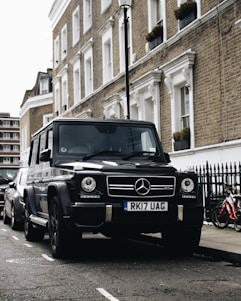 black Mercedes-Benz SUV parked beside road