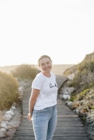 Smiling person wearing a personalized t-shirt with a vibrant nature photo.