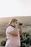A calm outdoor scene with a photographer capturing golden hour light on a subject.