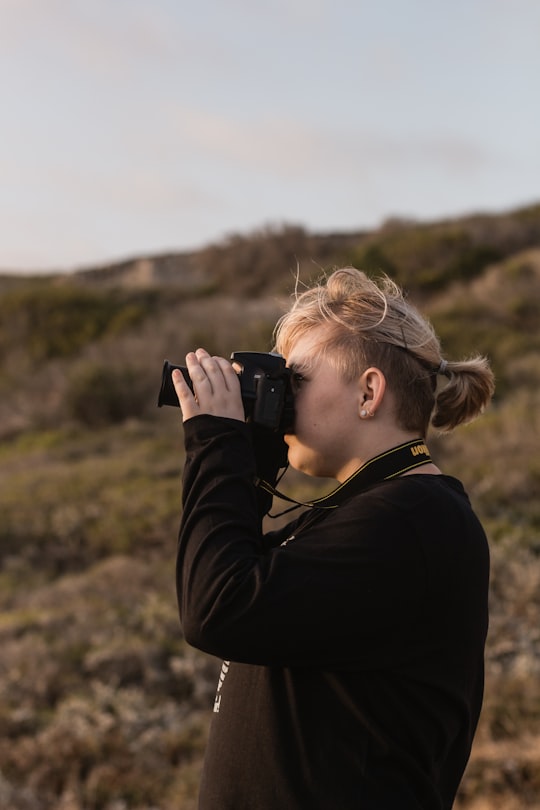 man using black DSLR camera in L'Agulhas South Africa