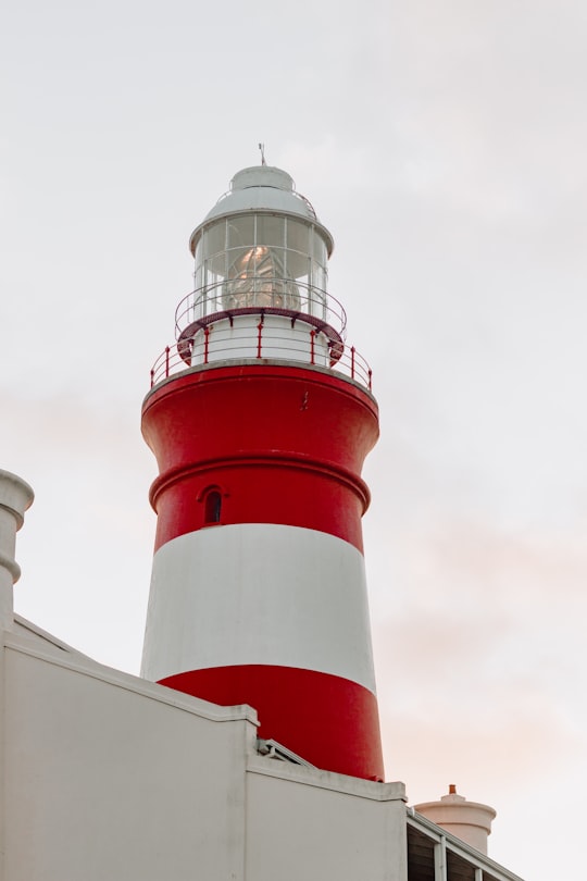 white and red lighthouse during daytime in Cape Agulhas Lighthouse South Africa
