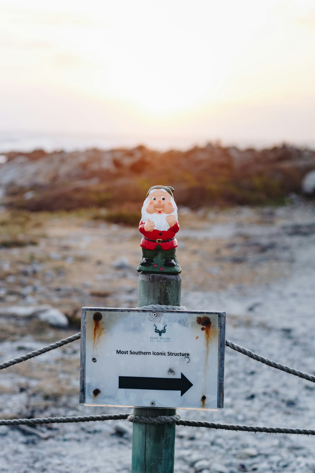 Santa gnome figurine on green wooden post