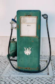 Side view of a restored gas pump showcasing intricate mechanical parts and aged patina.
