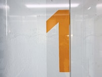 a white wall with a yellow number on it