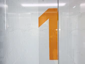 a white wall with a yellow number on it