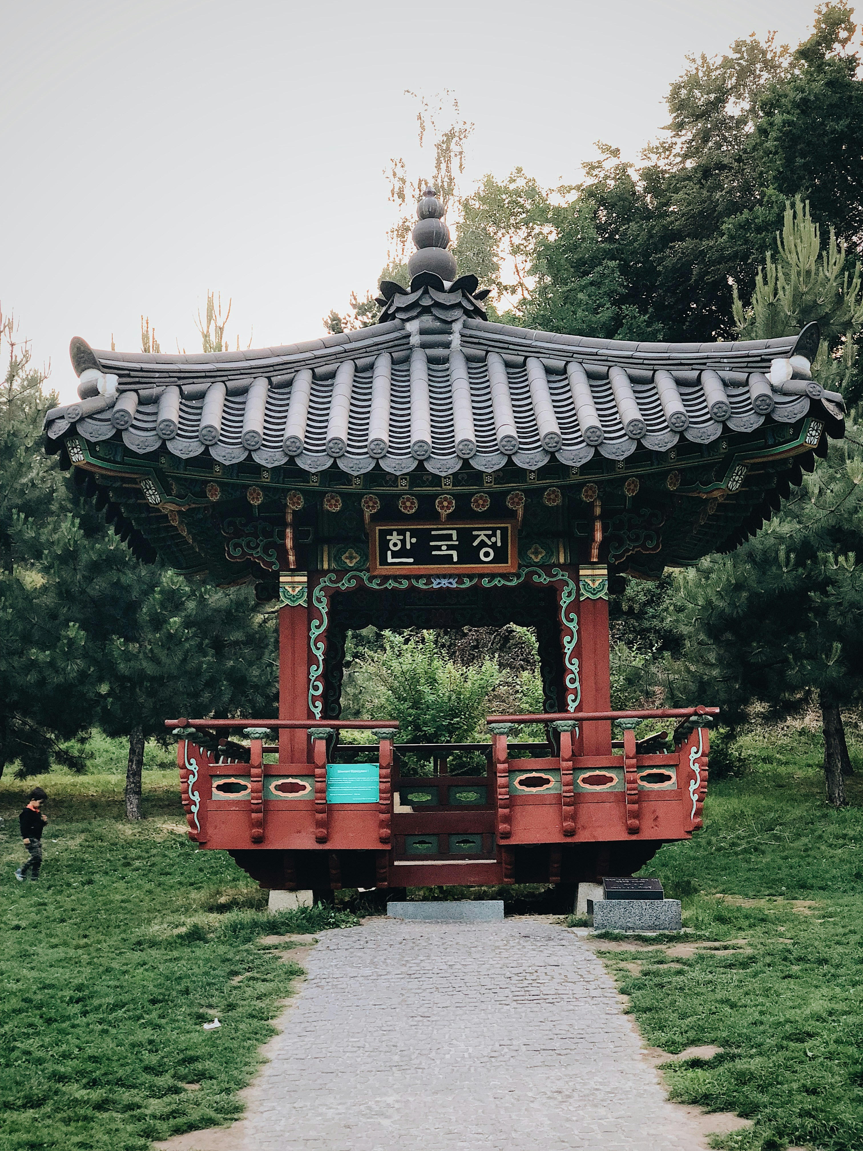 red and gray pagoda surrounded with green trees during daytime