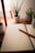 A serene workspace with a notebook, pen, and calming plants on a wooden desk.