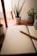 A serene workspace with a notebook, pen, and calming plants on a wooden desk.