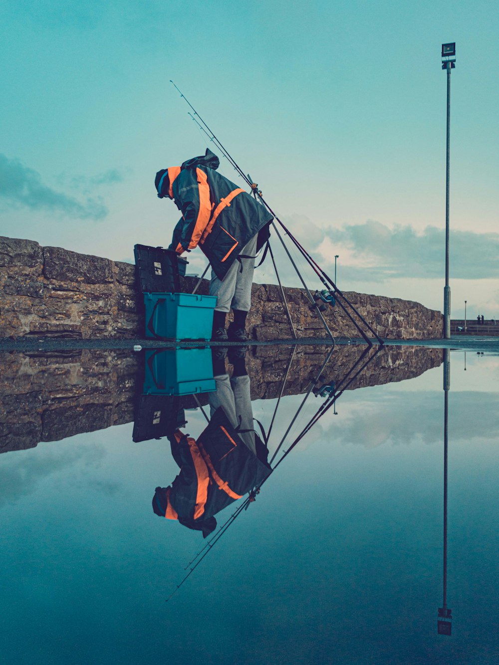 man fishing near sea