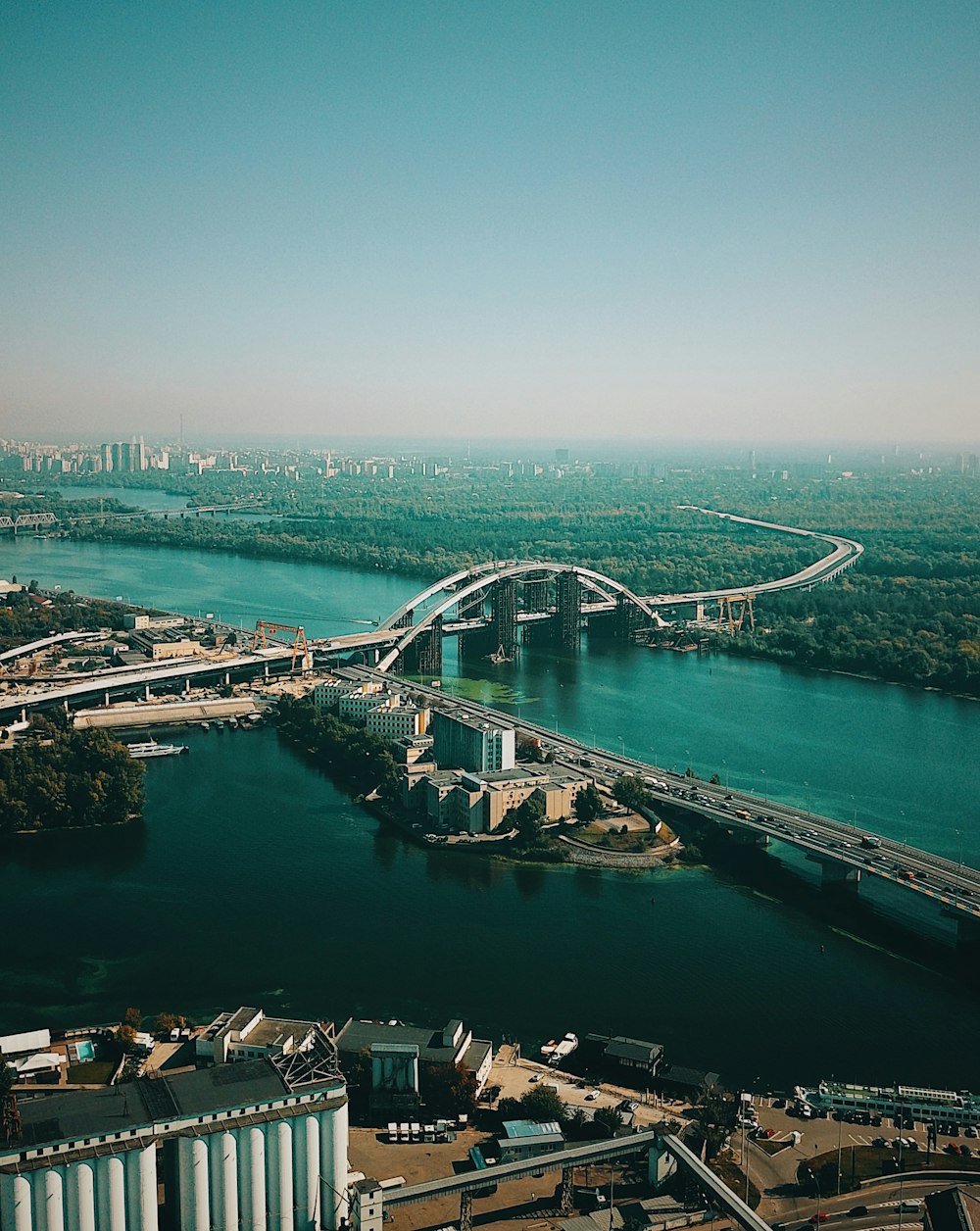 aerial view of bridges between trees and buildings