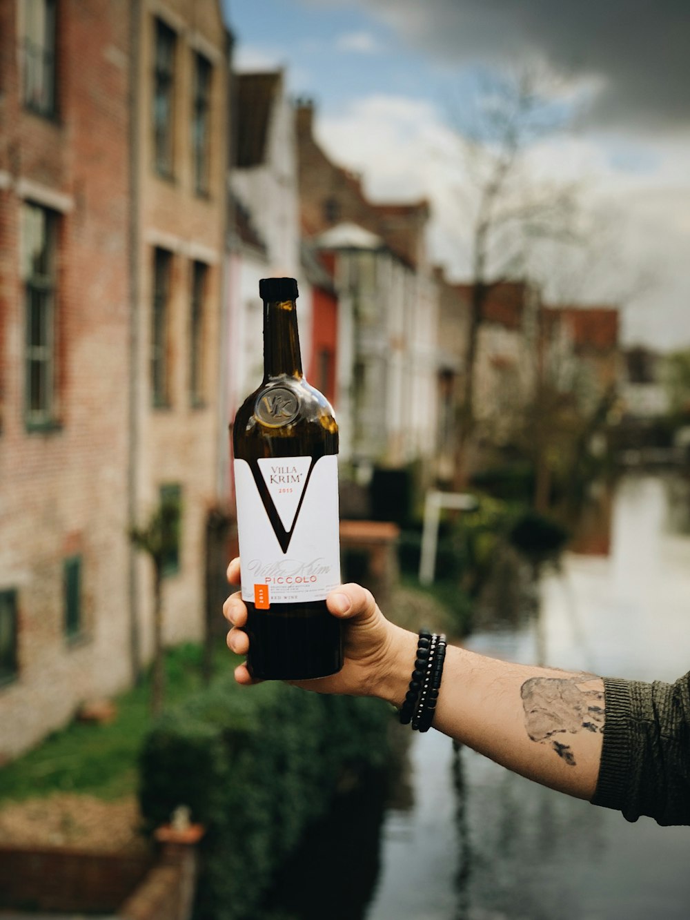 person holding V labeled bottle