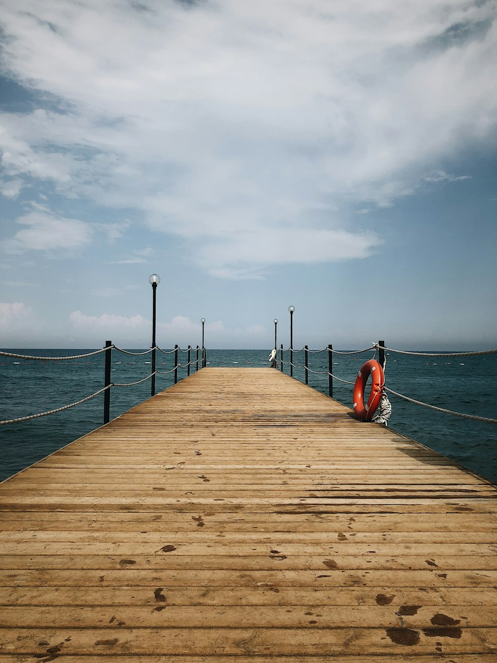 brown wooden pier under white sky