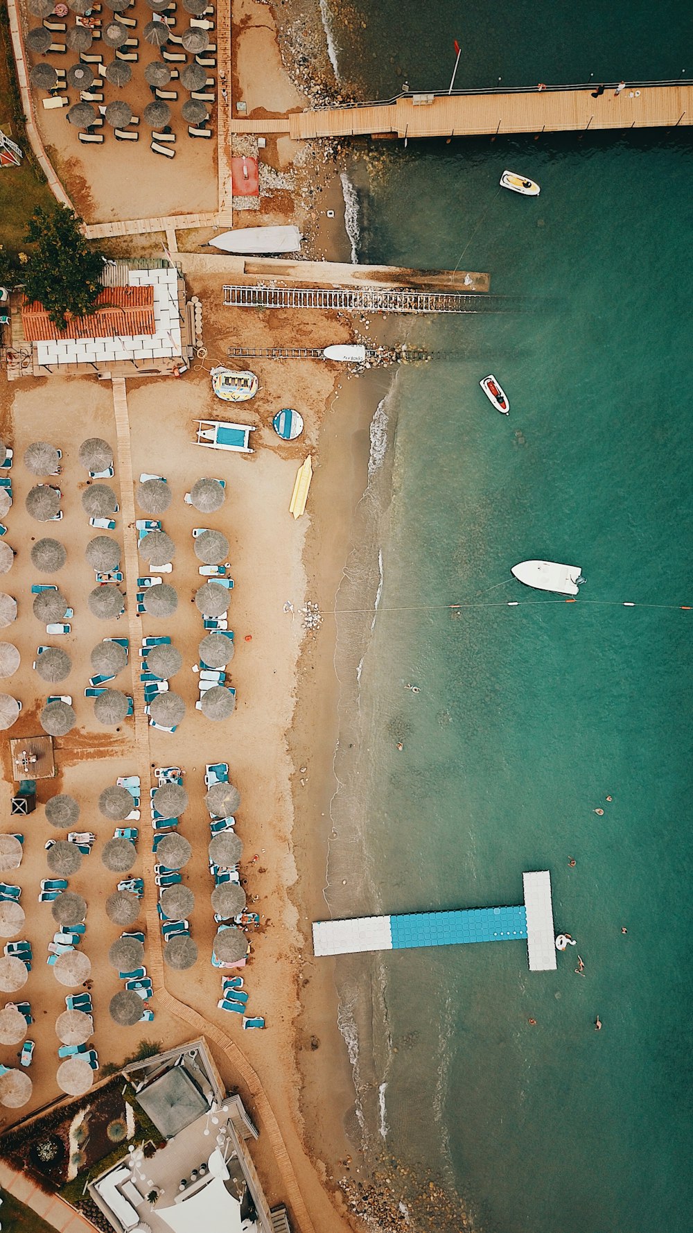 boats and parasols at the beach during day