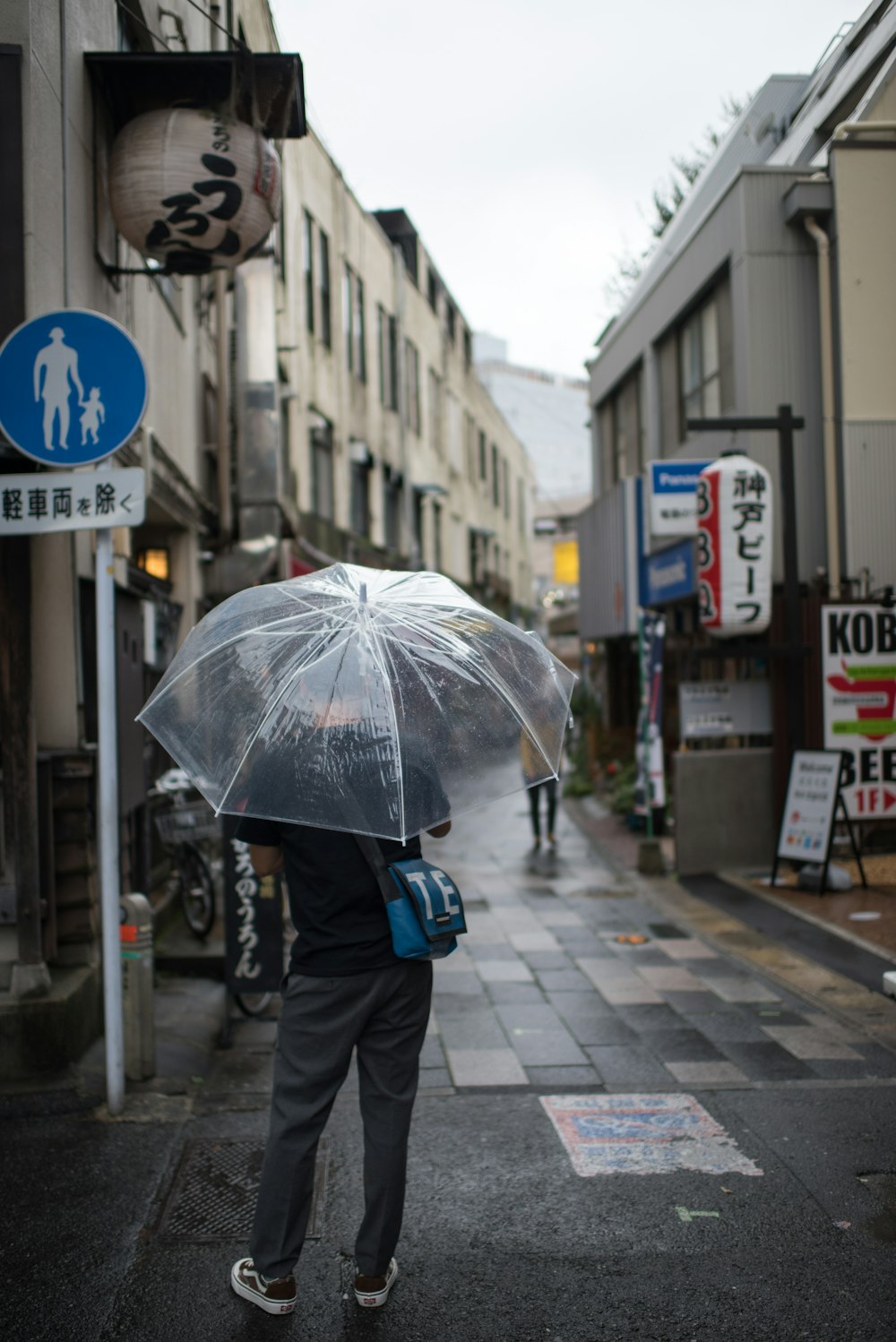 man using clear plastic umbrella