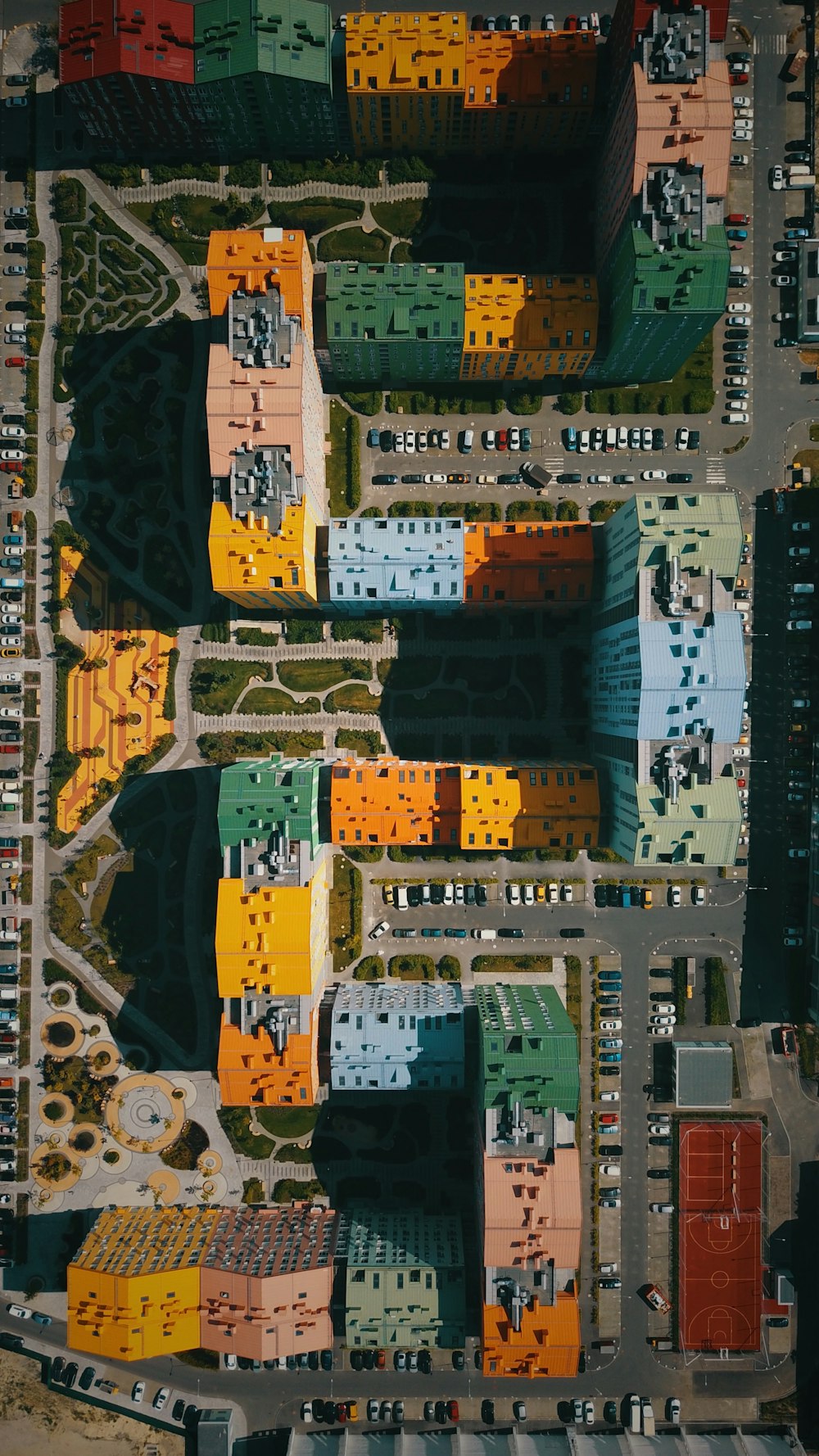 eagle eye photography of cars parked by buildings during daytime