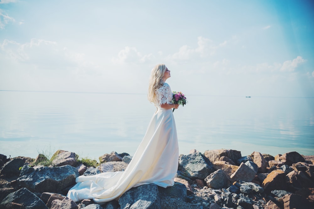 woman in white wedding dress with flowers