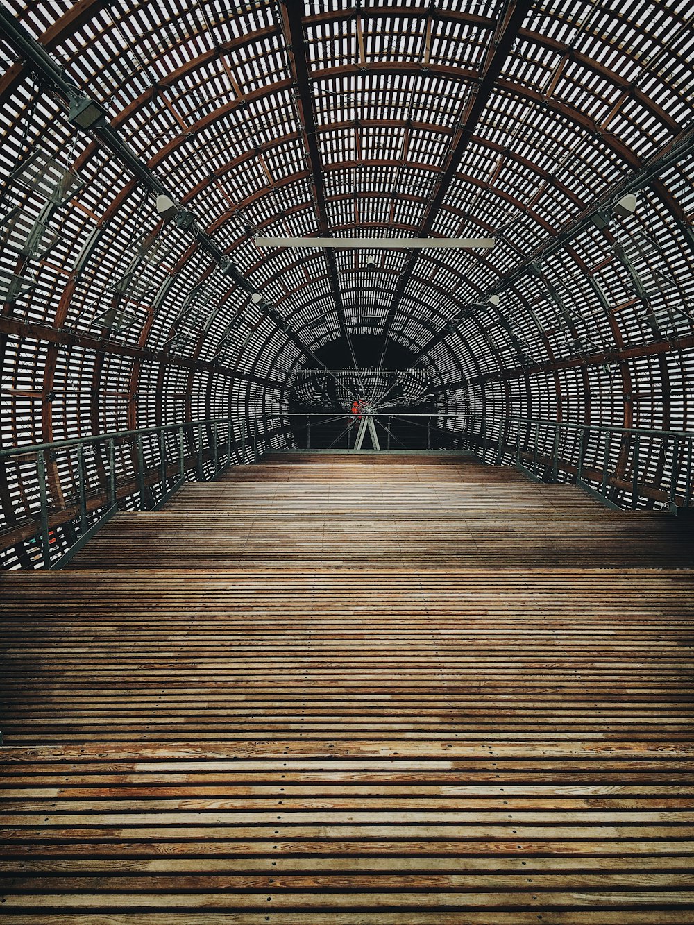 a wooden floor inside of a metal structure