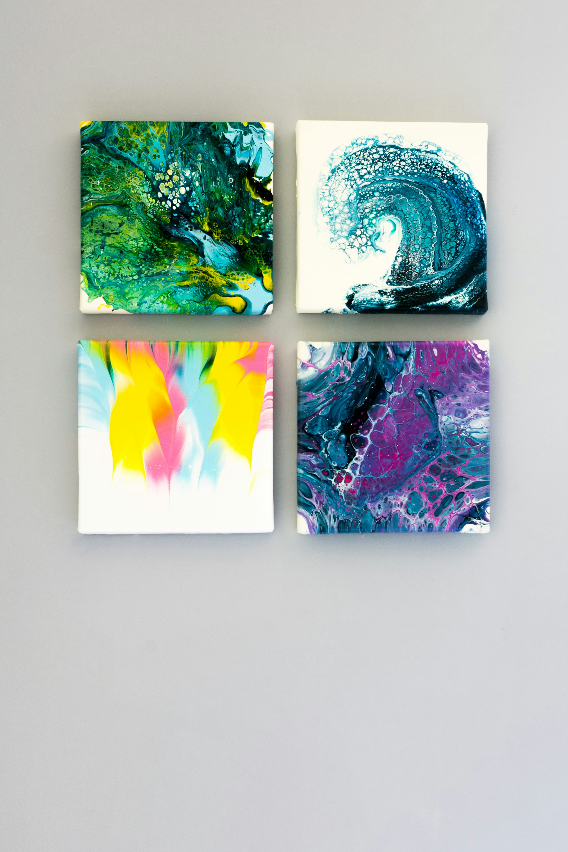 A modern art portfolio panel featuring colorful abstract paintings arranged neatly with ample white space.