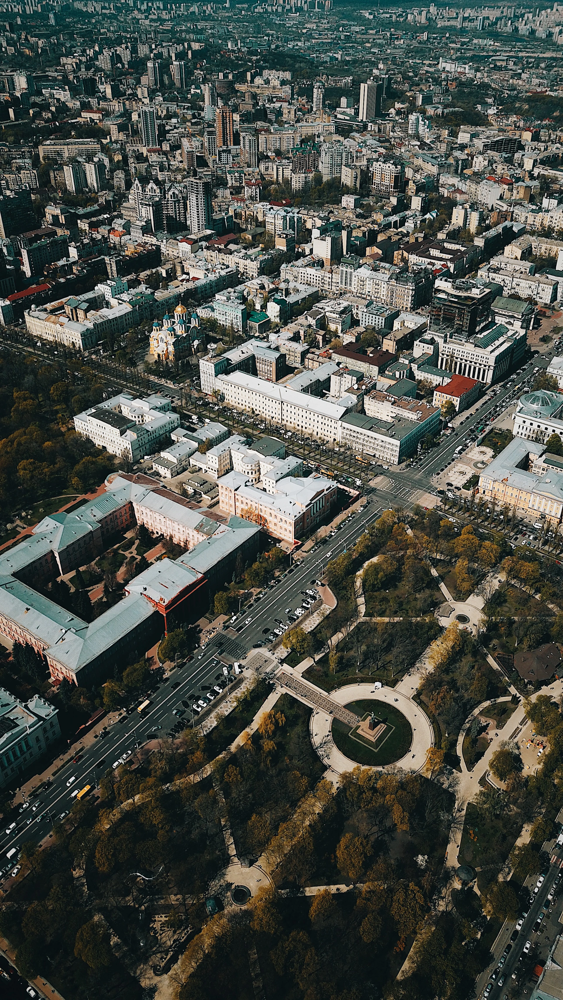 An aerial view of an ongoing urban planning project showcasing a grid layout with green spaces and roads.