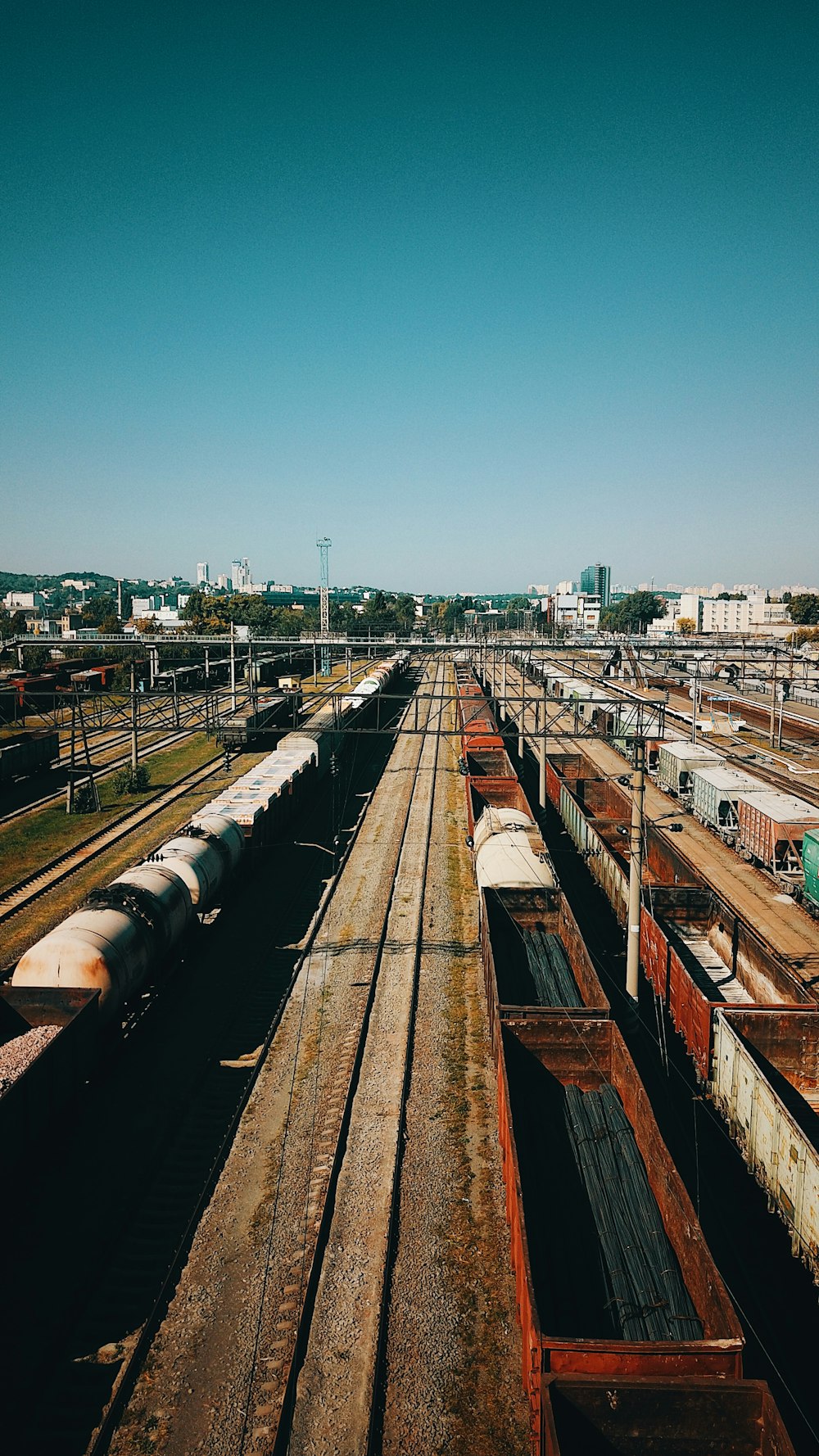 aerial photography of train railway viewing buildings and houses during daytime