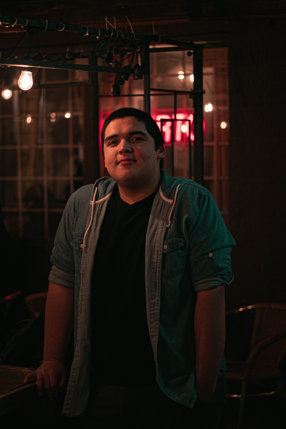 man standing beside table