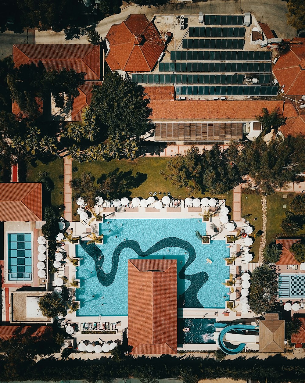 aerial photography of houses and building near rectangular swimming pool during daytime