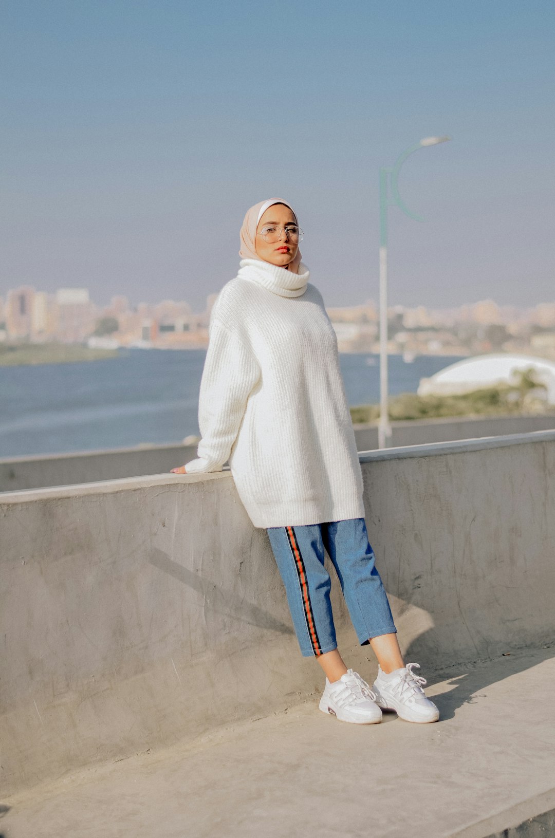 woman leaning on concrete fence