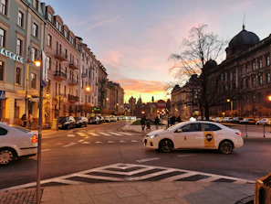 Sunset view of a tuktuk crossing a charming street with traditional Madrid balconies