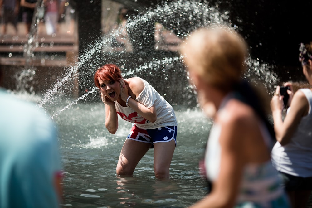 people playing on water fountain