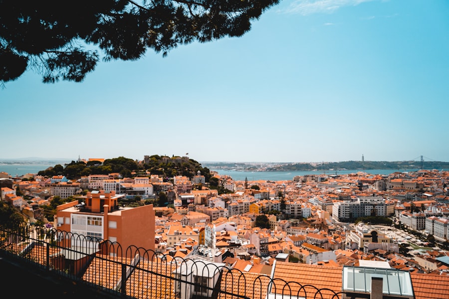 Lisbon's colorful hillside neighborhoods overlooking the Tagus River at golden hour