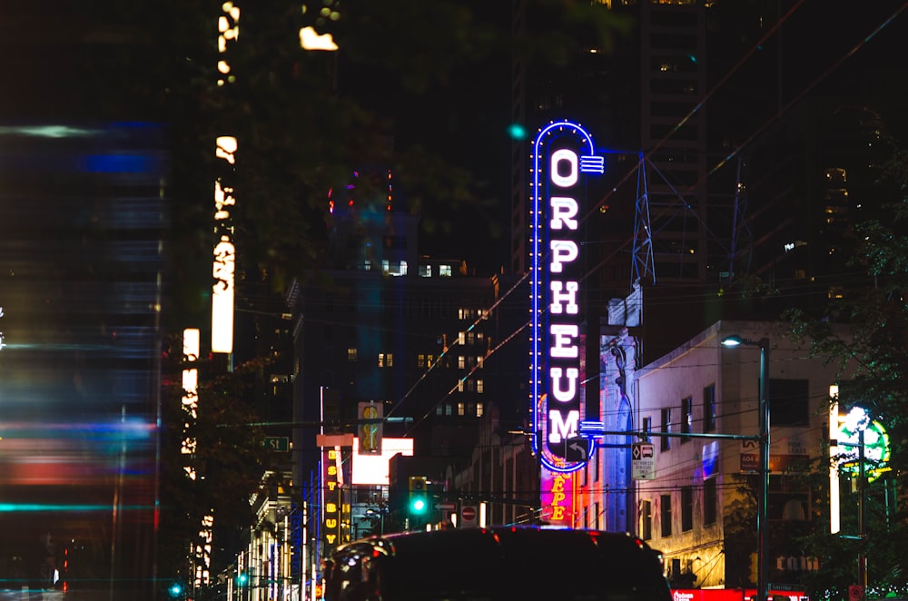 city buildings with lights turned on during night time