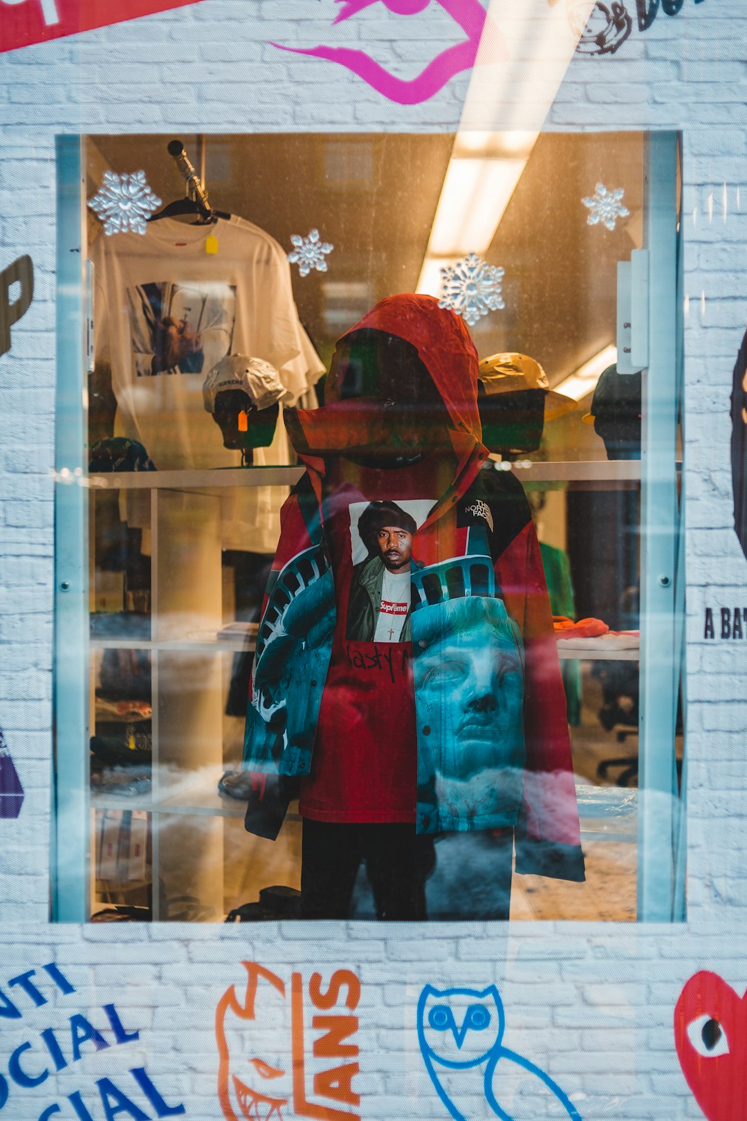 red hoodie displayed inside shop by the window