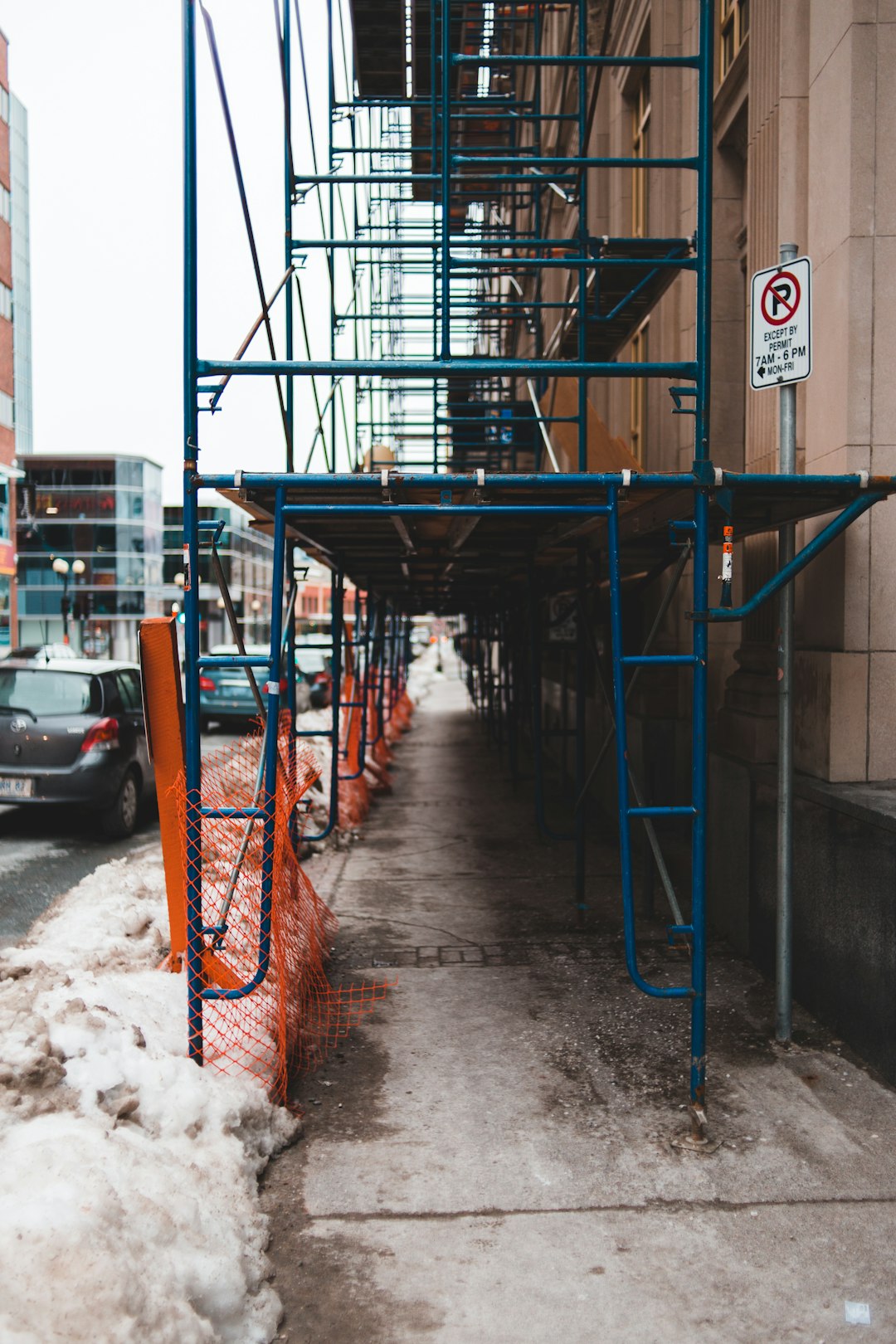 blue scaffolding near concrete building