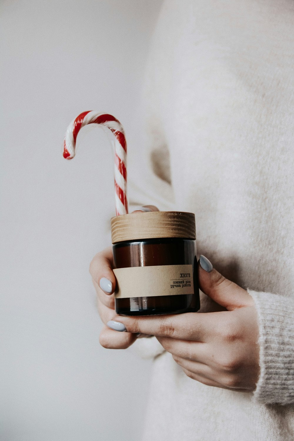 shallow focus photo of person holding black glass jar