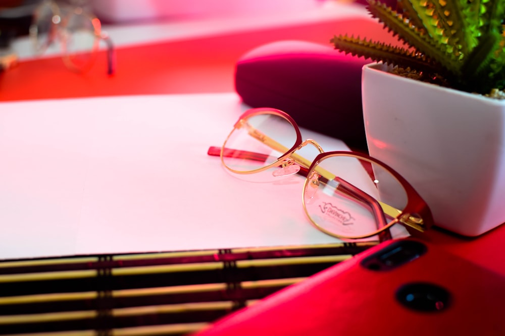 shallow focus photo of eyeglasses with brown frames