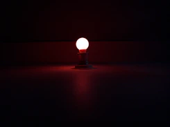 Compact mini portable trimmer glowing softly with blue neon light on a dark surface