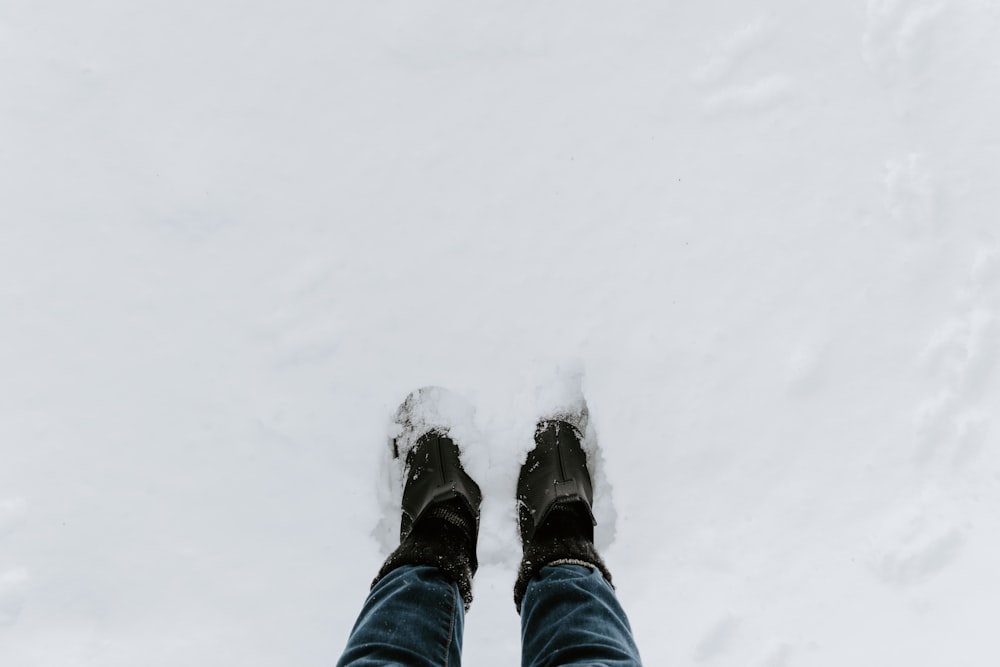 person standing on snow covered field