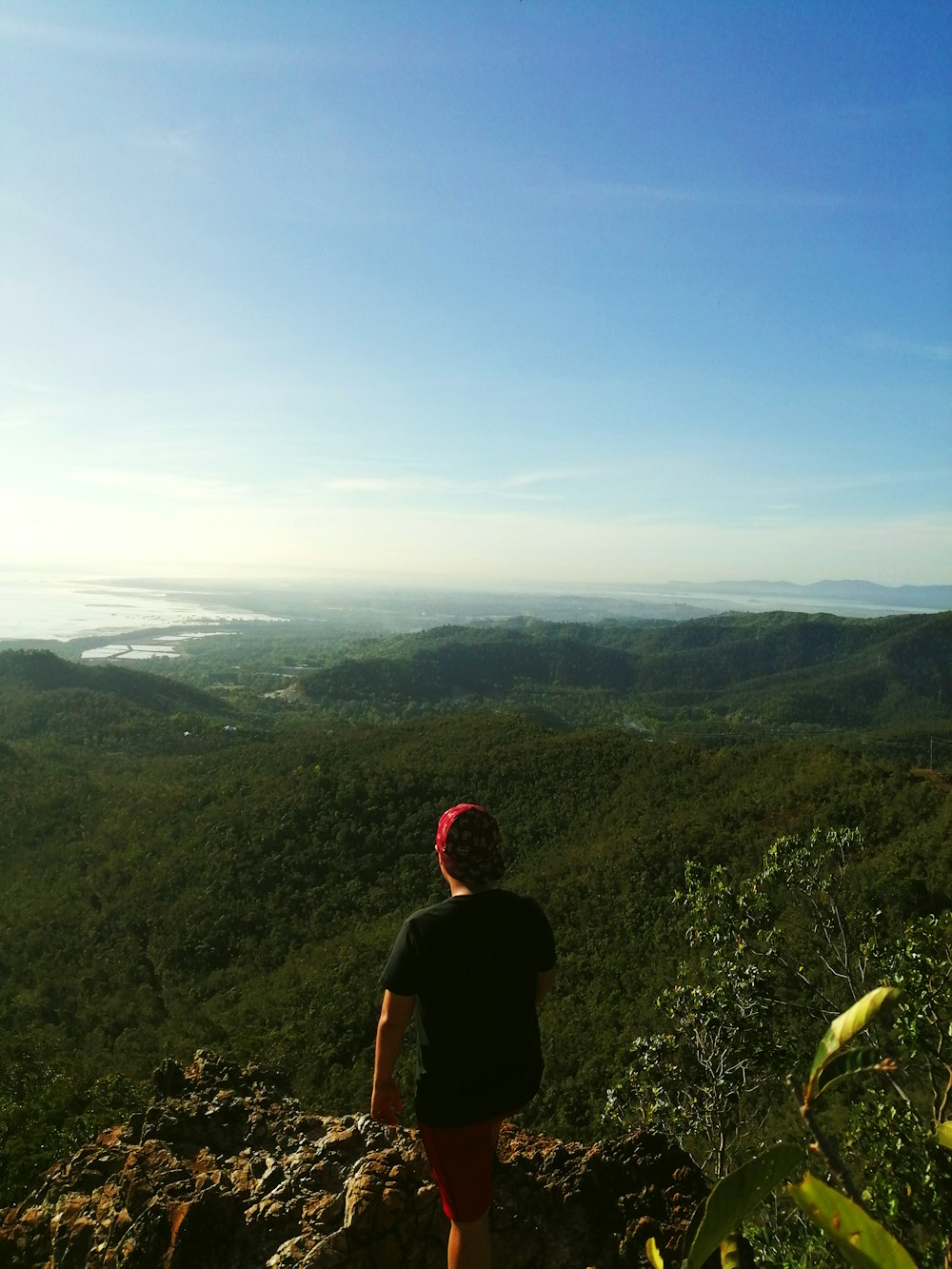 person standing on mountain during daytime