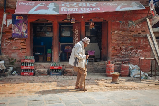 person walking outside a storefront in Kathmandu Nepal