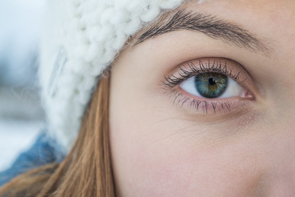 close-up photography of woman with blue-green right eye