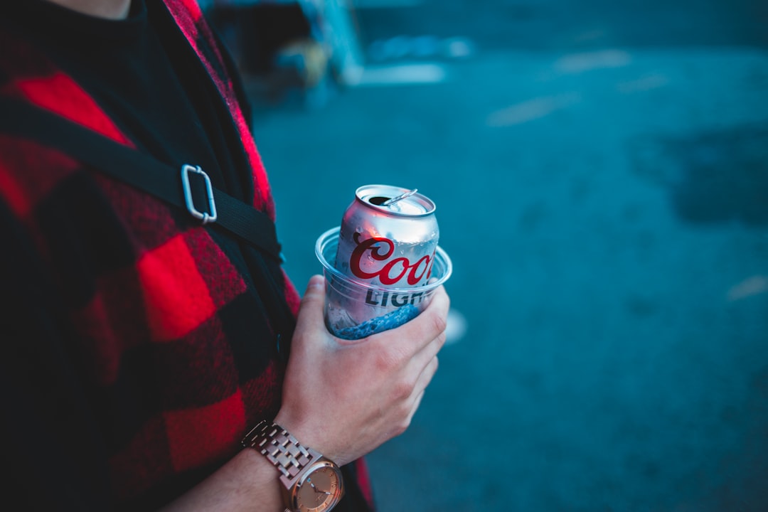 person holding Coors Light beer can
