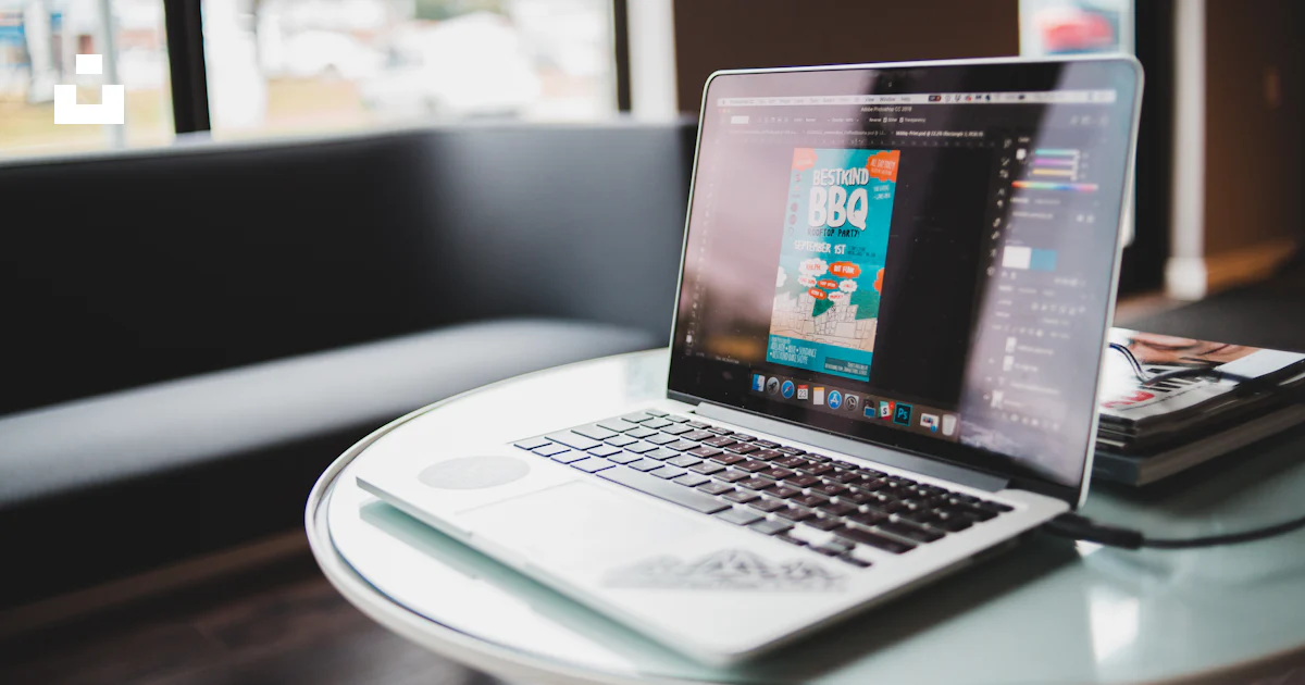 MacBook Pro near books on round white table photo – Free Computer Image ...