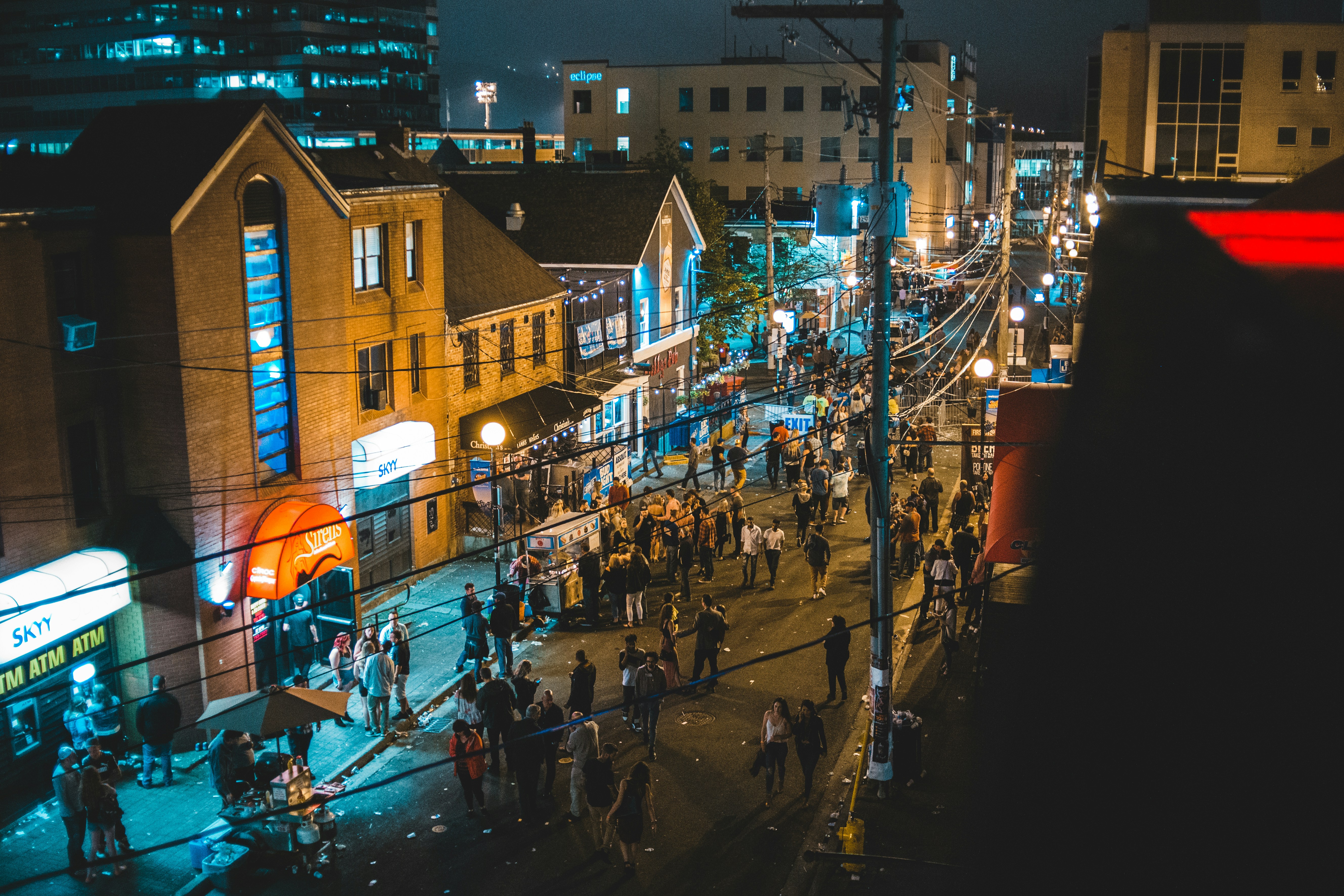 aerial photography of people along a city street during nighttime, 