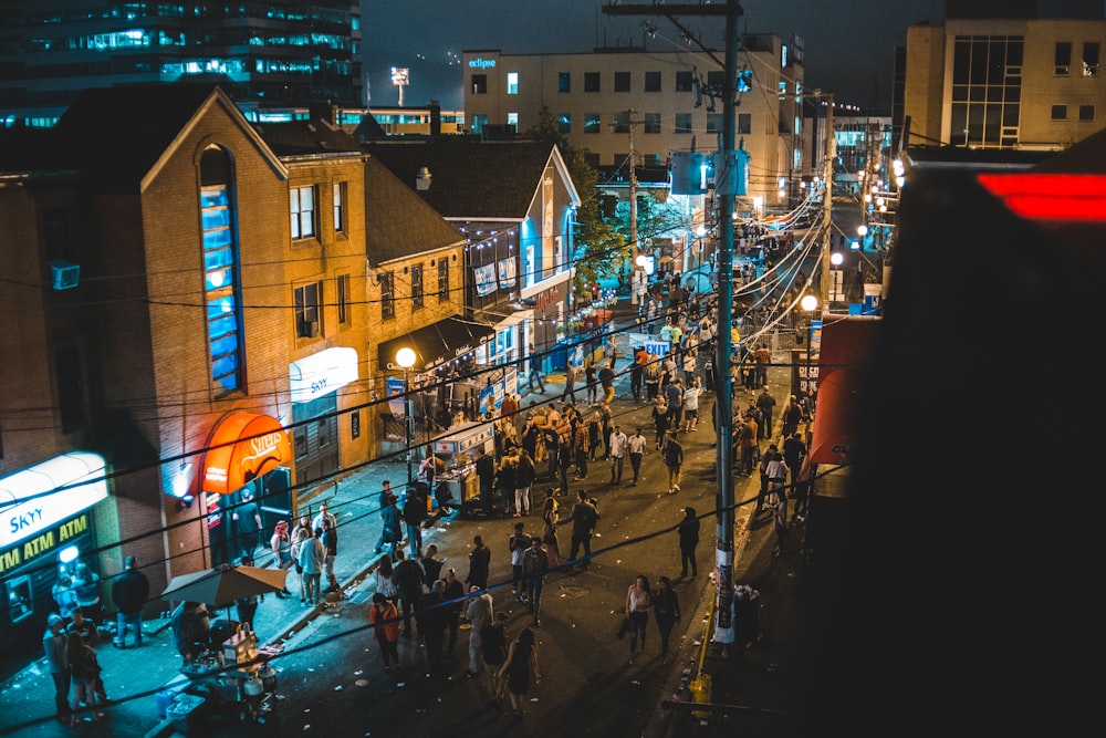 aerial photography of people along a city street during nighttime