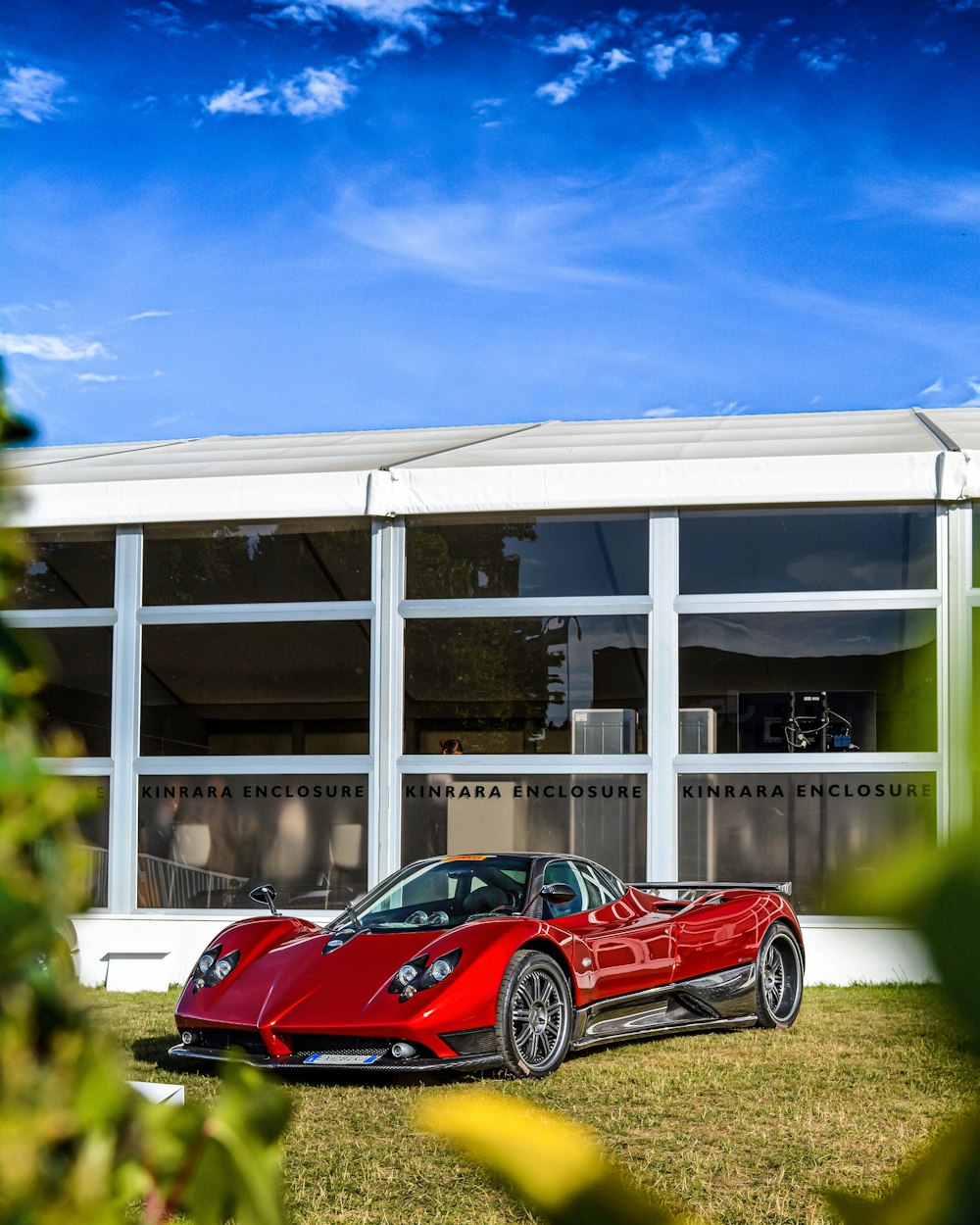 red sports coupe outside the building