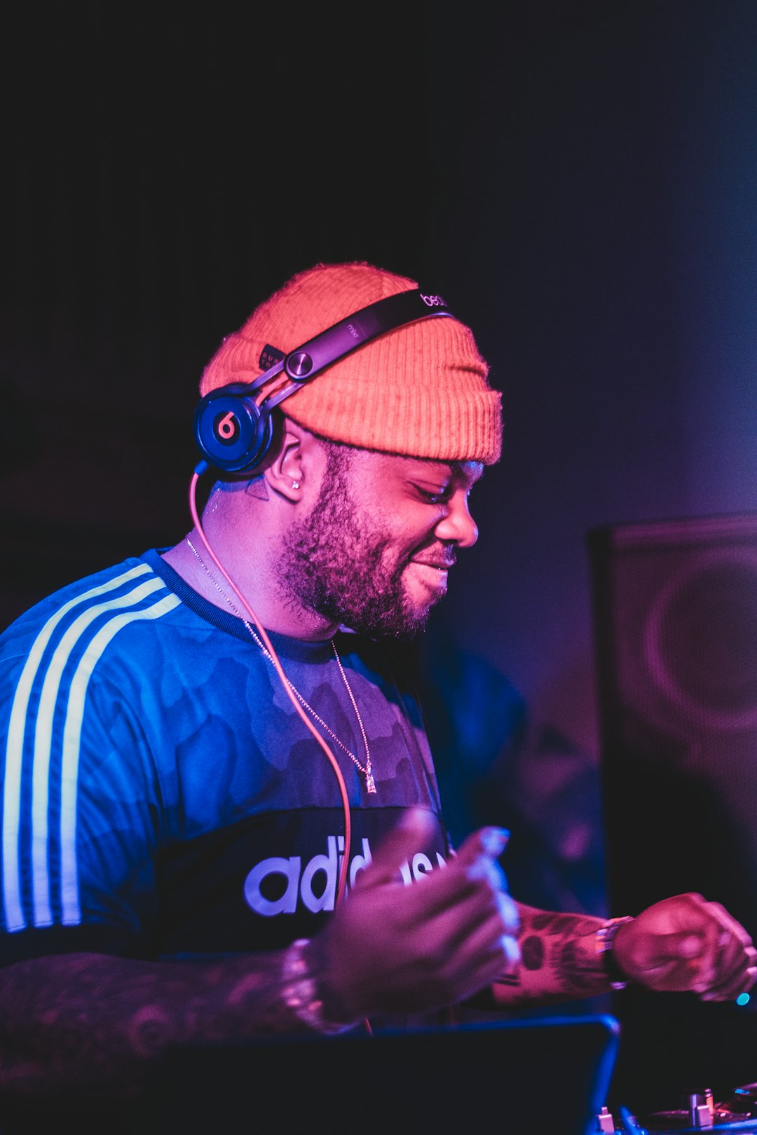 man wearing black Beats by Dre corded headphones