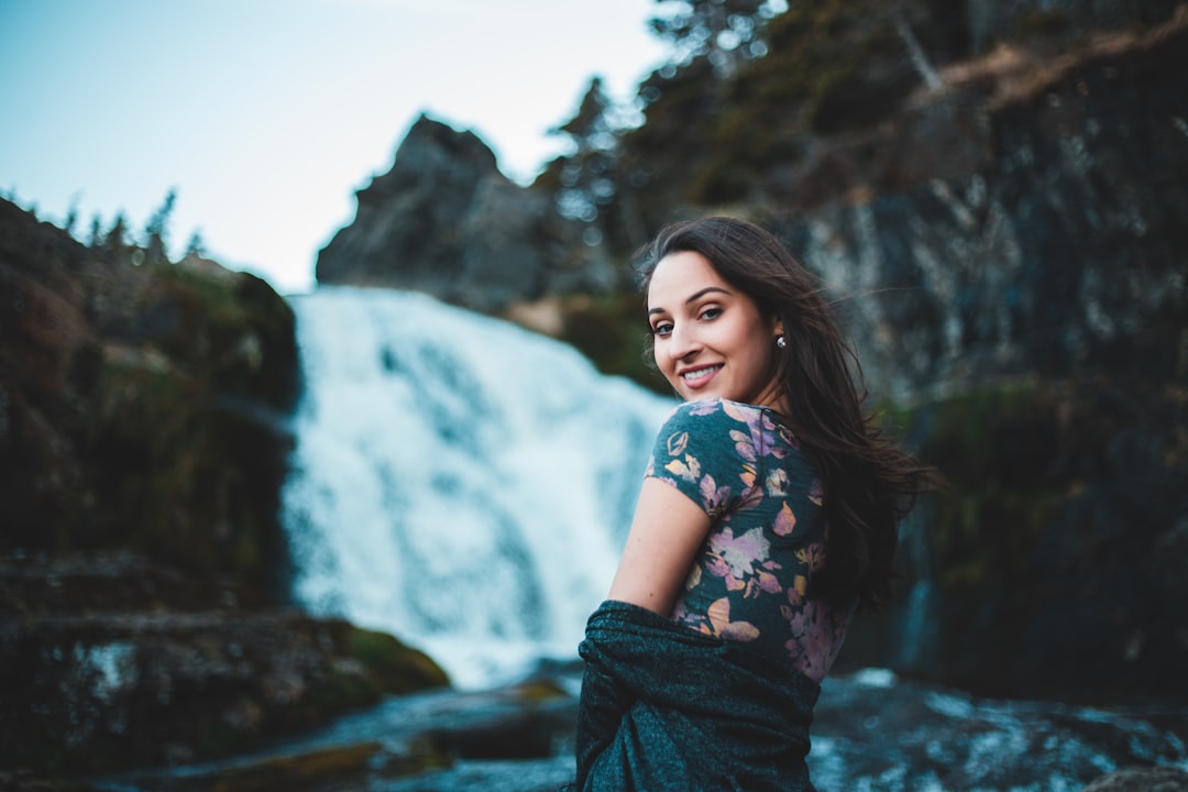 woman looking over her shoulder with waterfall in the background