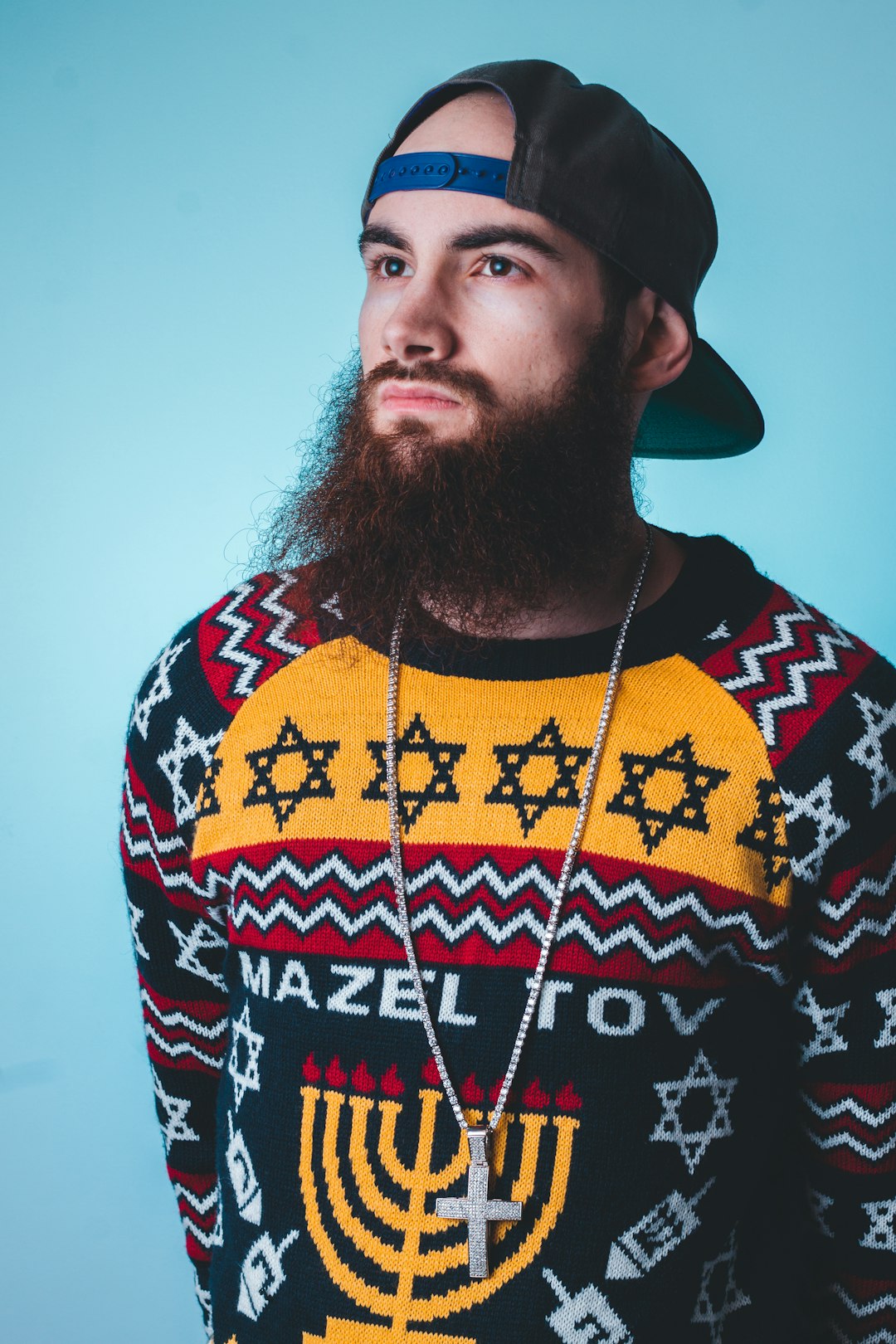 man wearing black, yellow, and red sweatshirt