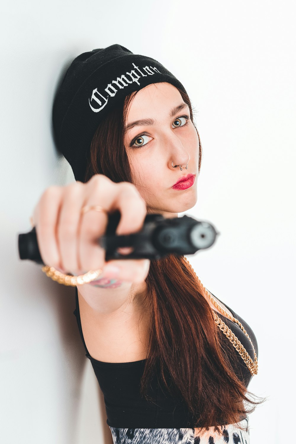 woman holding a black semi-automatic pistol