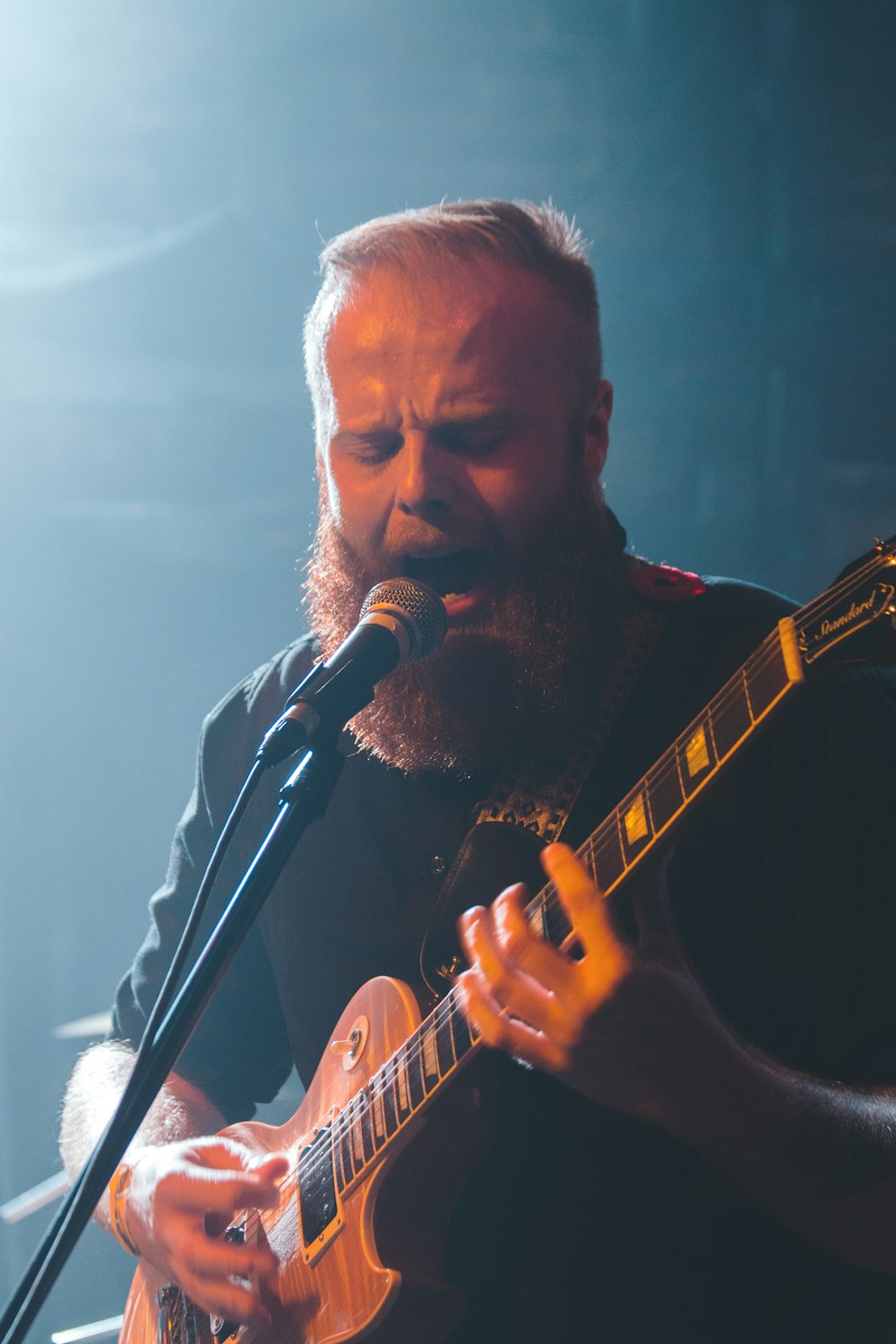 man singing and playing guitar